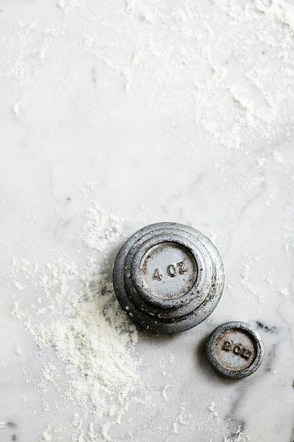 Weights On A Floured Marble Surface Photograph by Victoria Firmston