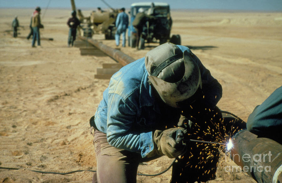 Welding Being Carried Out On A Pipe In The Desert Photograph by Occidental Consortium/science Photo Library