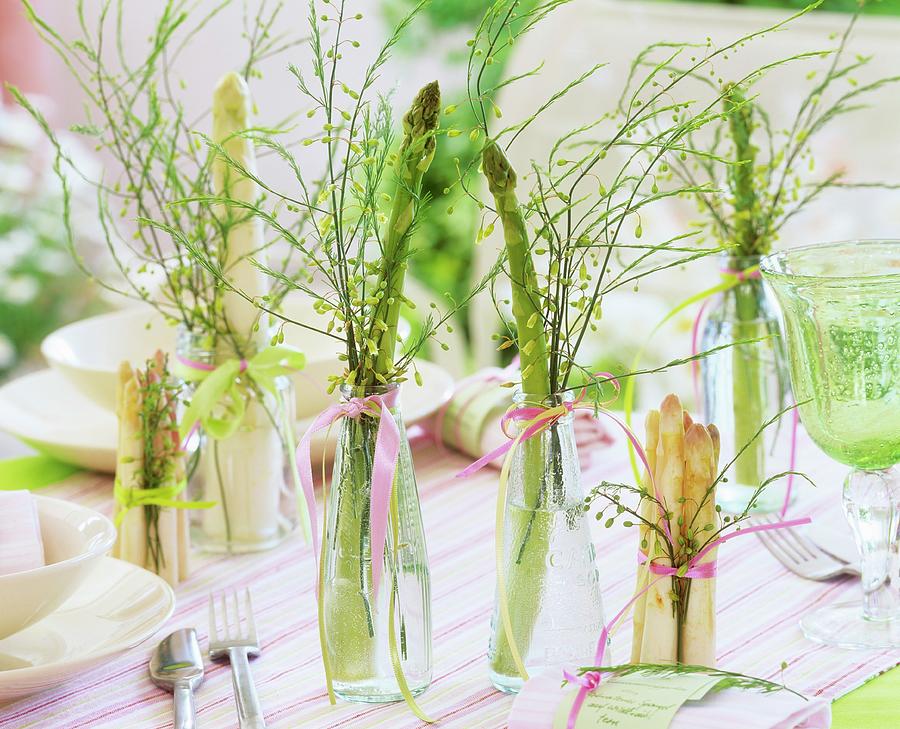 White And Green Asparagus In Glass Bottles On Laid Table Photograph by Strauss, Friedrich