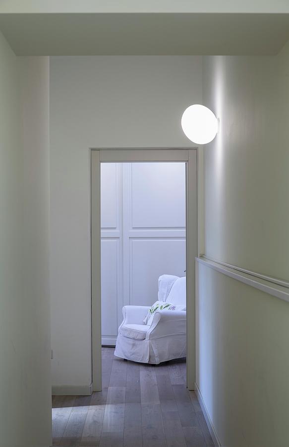 White Armchair Seen Through Open Door In Hallway Photograph by Laura Rizzi