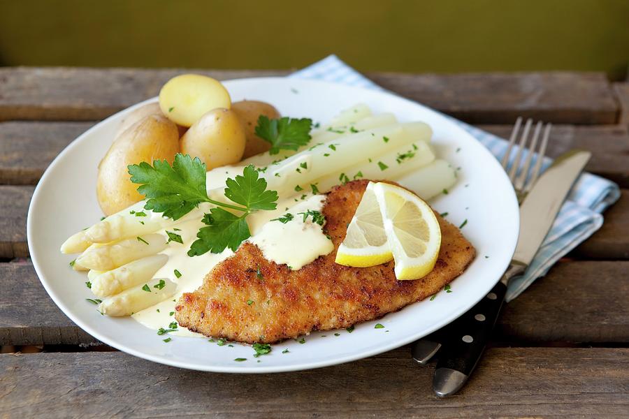 White Asparagus And A Schnitzel With Hollandaise Sauce And Potatoes ...