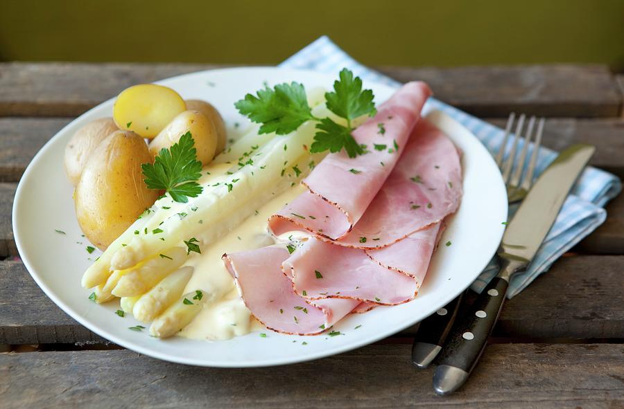White Asparagus And Boiled Ham With Hollandaise Sauce And Potatoes Photograph by Foodografix