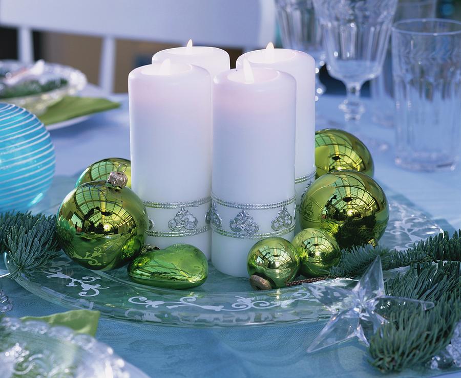 White Candles And Christmas Baubles On Glass Plate Photograph by Friedrich Strauss