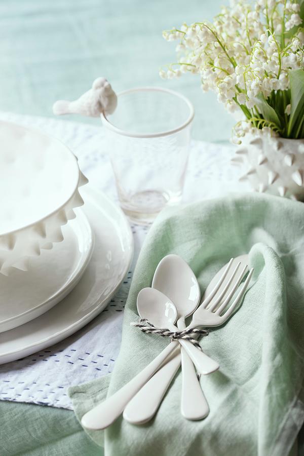 White Ceramic Cutlery On Pastel Green Napkin Next To Place Setting Photograph by Annette Nordstrom