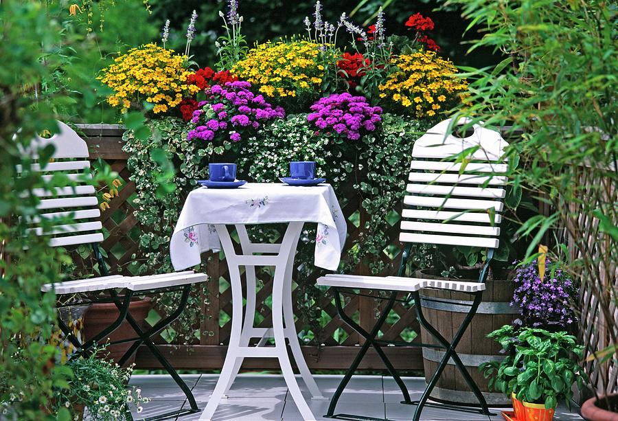 White Chairs And Table In Front Of Window Boxes On Balcony Photograph by Friedrich Strauss