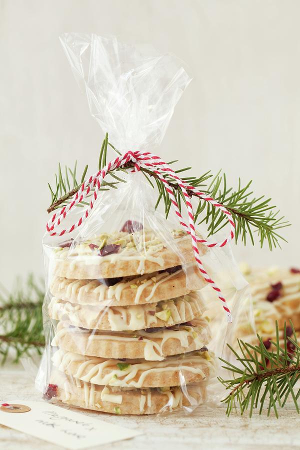 White Chocolate Biscuits With Pistachios And Cranberries In A Cellophane Bag As A Gift Photograph by Jane Saunders