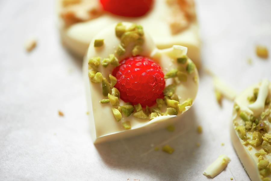 White Chocolate Heats With Pistachios And Raspberries Photograph by Hugo Monteros