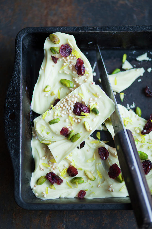 White Chocolate With Amaranth, Cranberries, Pistachio Nuts And Edible Flowers Photograph by Katrin Winner