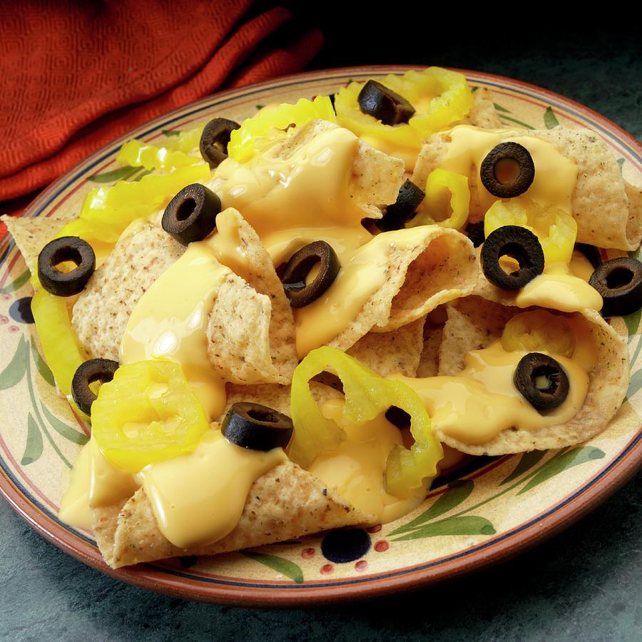 White Corn Tortilla Chips With Cheese Sauce, Black Olives And Banana Peppers Photograph by Paul Poplis