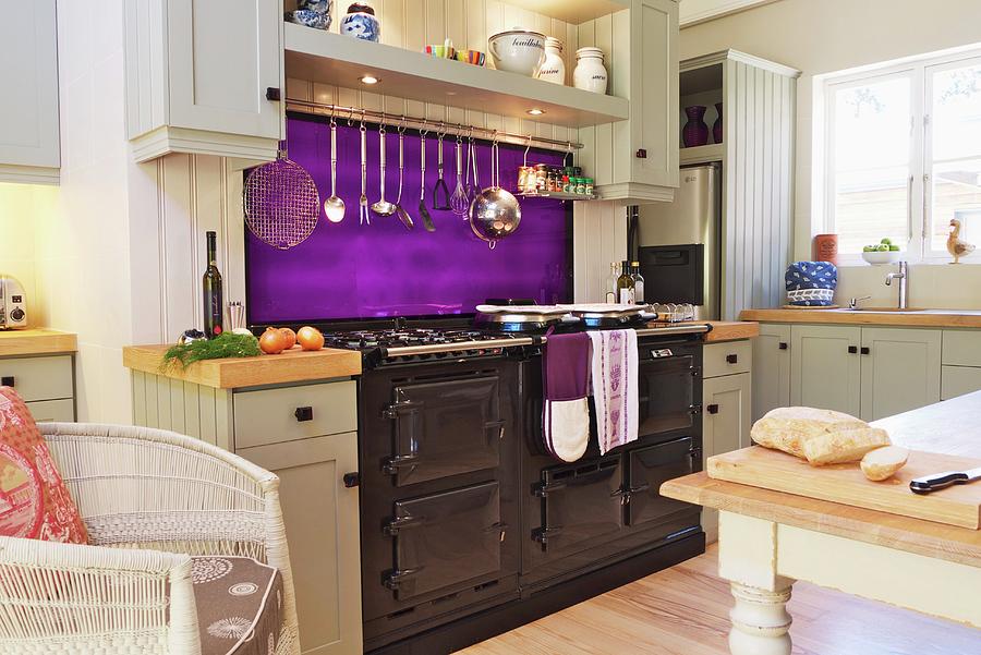 White, Country-house-style Kitchen With Bright Purple Splashback And Large, Metal-fronted Cooker Photograph by Great Stock!