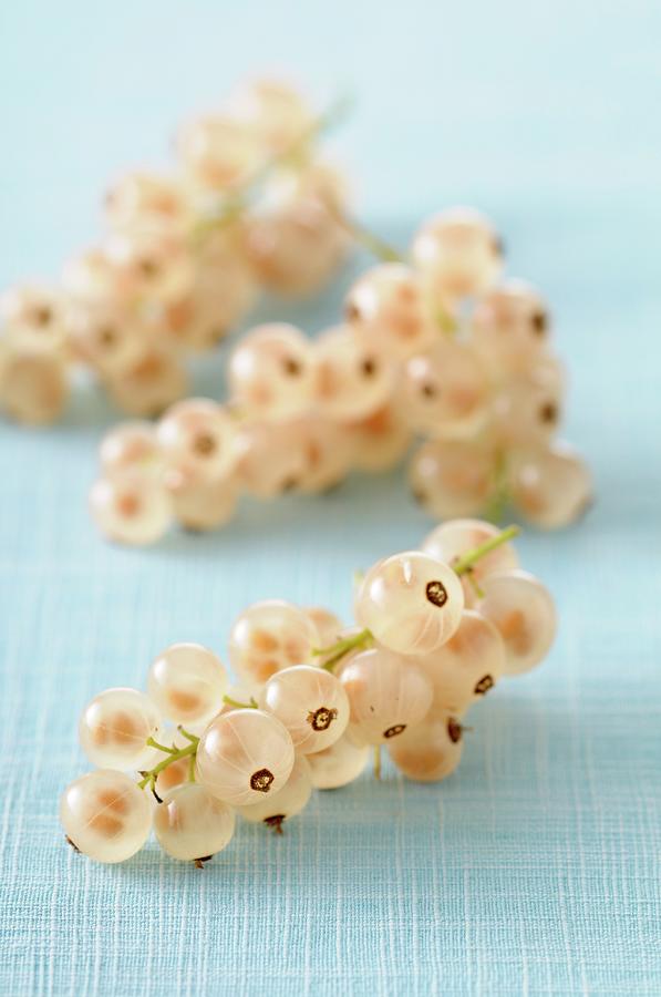 White Currants On A Pastel-coloured Tablecloth Photograph by Jean-christophe Riou