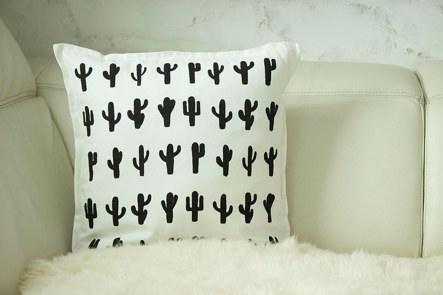 White Cushion With Printed Pattern Of Black Cacti Photograph by Astrid Algermissen