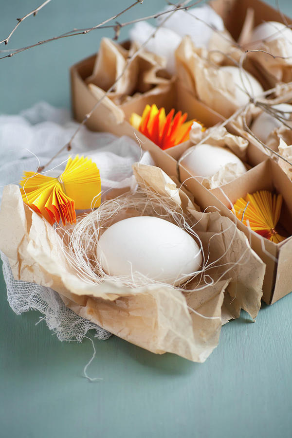 White Eggs And Yellow Paper Rosettes Photograph by Alicja Koll