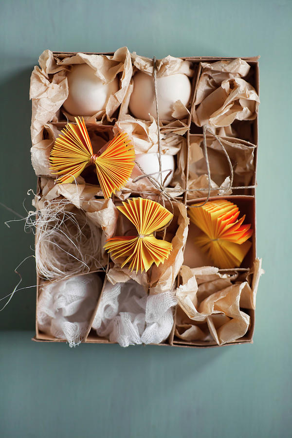 White Eggs And Yellow Paper Rosettes In Box Photograph by Alicja Koll