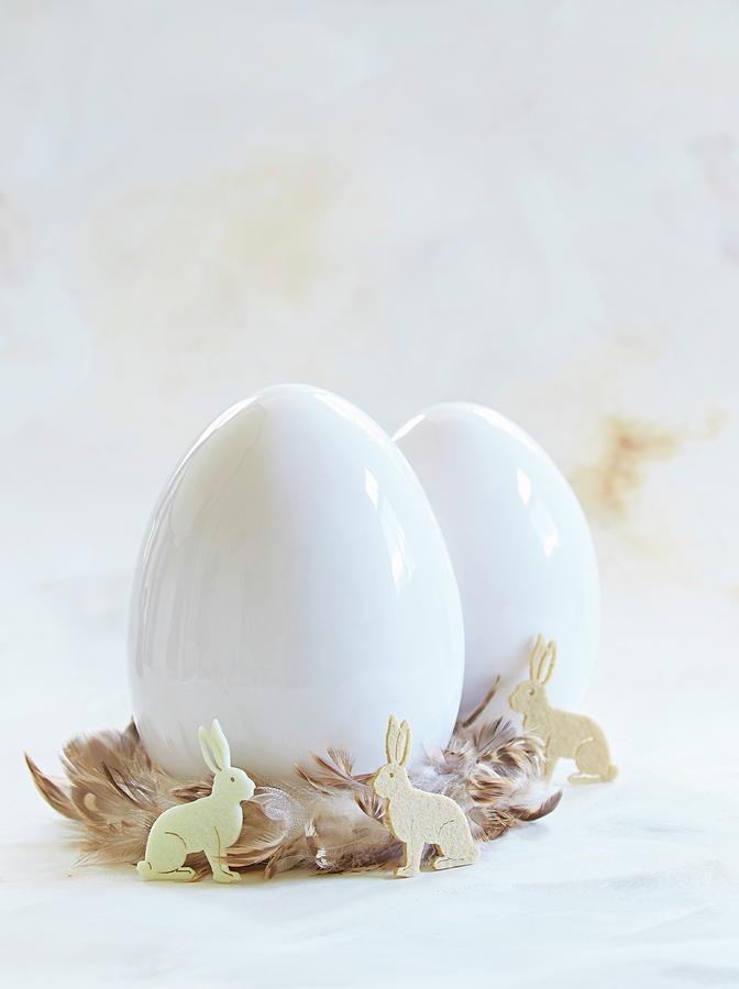 White Eggs In Nests Of Feathers With Easter Bunnies Photograph by Sven C. Raben