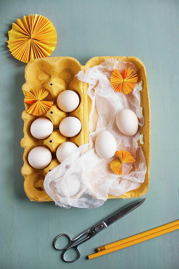 White Eggs, Muslin And Yellow Paper Rosettes In Yellow Egg Box Photograph by Alicja Koll