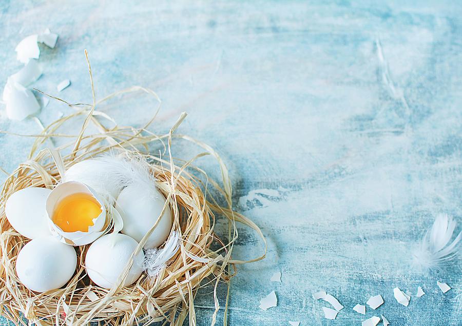 White Eggs, Whole And Cracked Open, In A Straw Nest Photograph by Olimpia Davies
