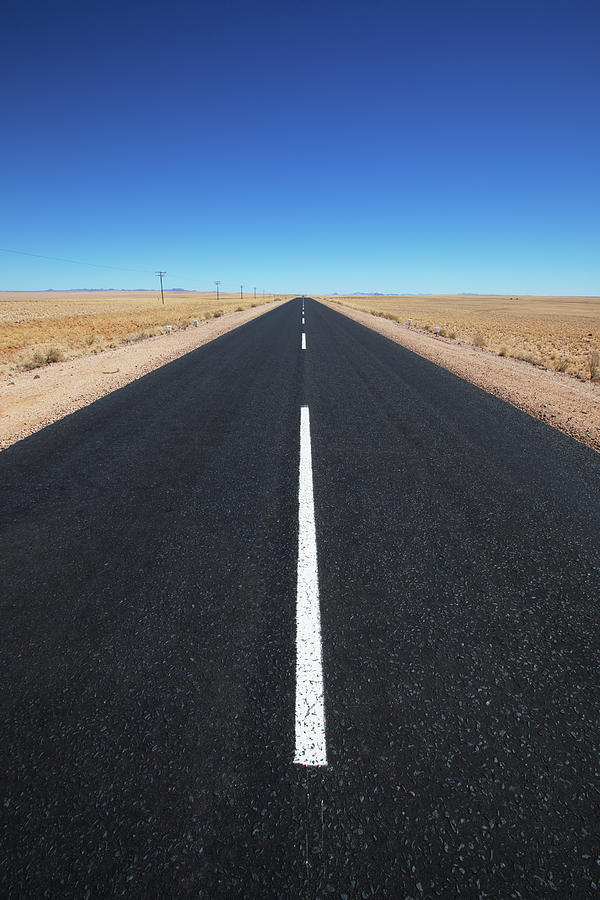 White Line On A Paved Road In The Desert Photograph by Lars Froelich / Design Pics