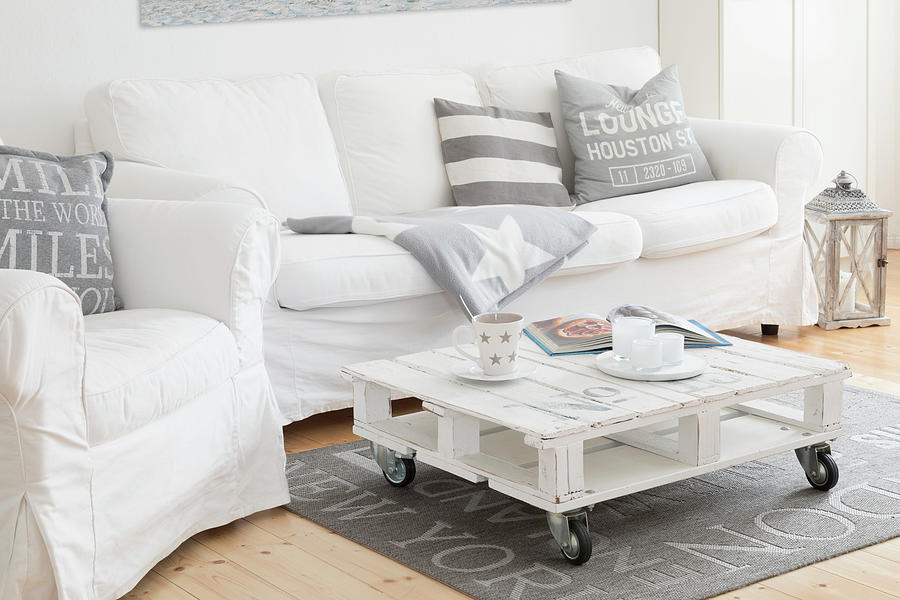 White, Loose-covered Sofa Set And Pallet Coffee Table In Living Room Of Converted Dairy Photograph by Uwe Merkel