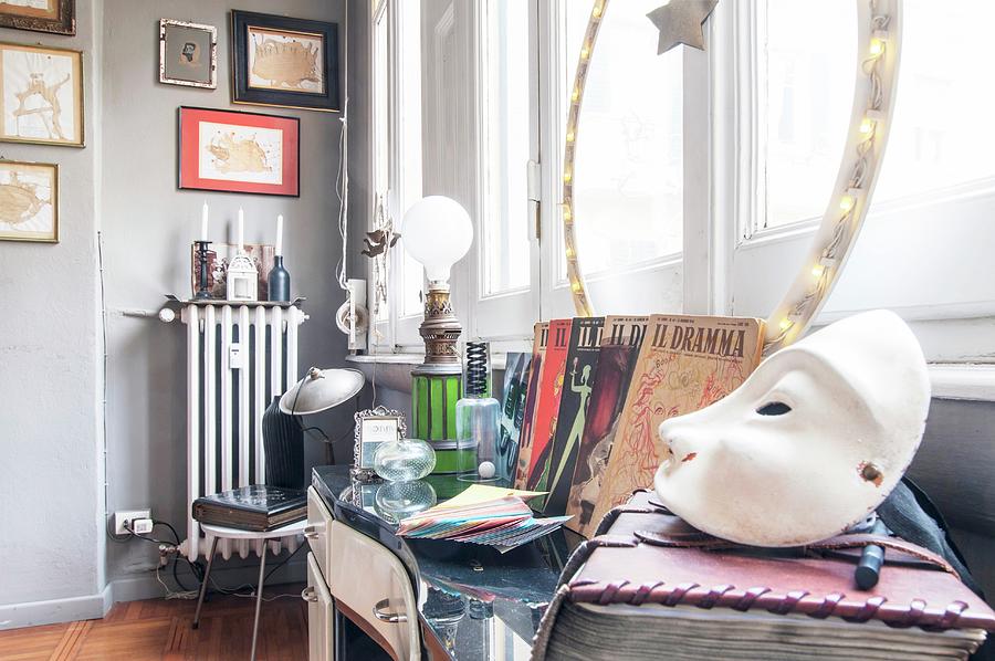 White Mask In Foreground And Flea-market Finds On Table In Front Of Window Photograph by Andrea Cuscuna