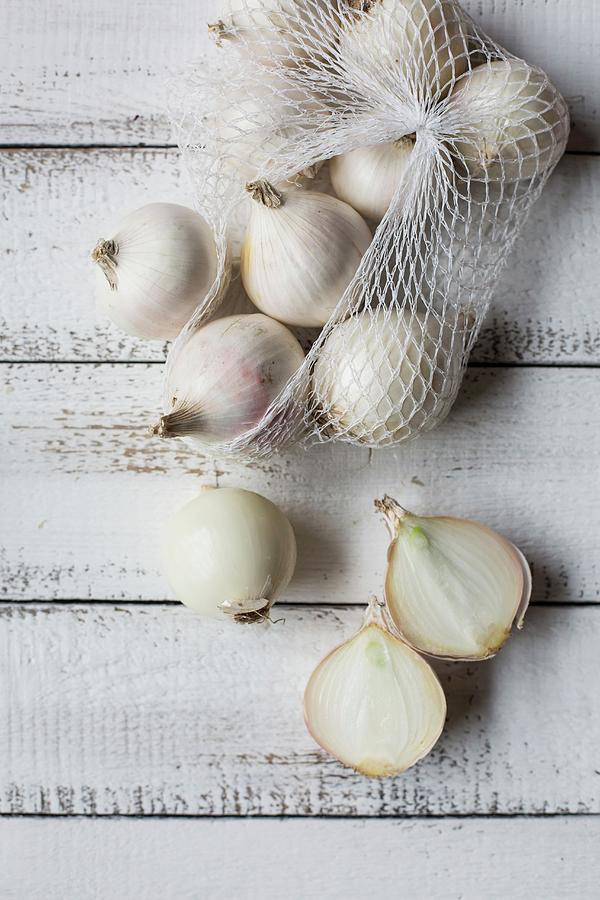 White Onions On A White Wooden Table Photograph by Sabine Steffens
