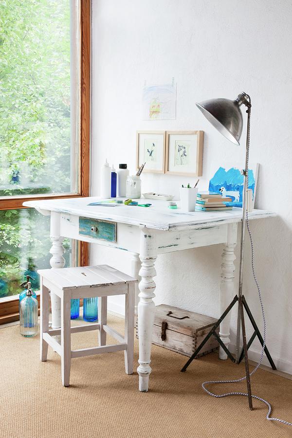 White-painted Wooden Table With Turned Legs And Vintage-look Stool Next To Retro, Metal Standard Lamp In Corner Photograph by Sabine Lscher