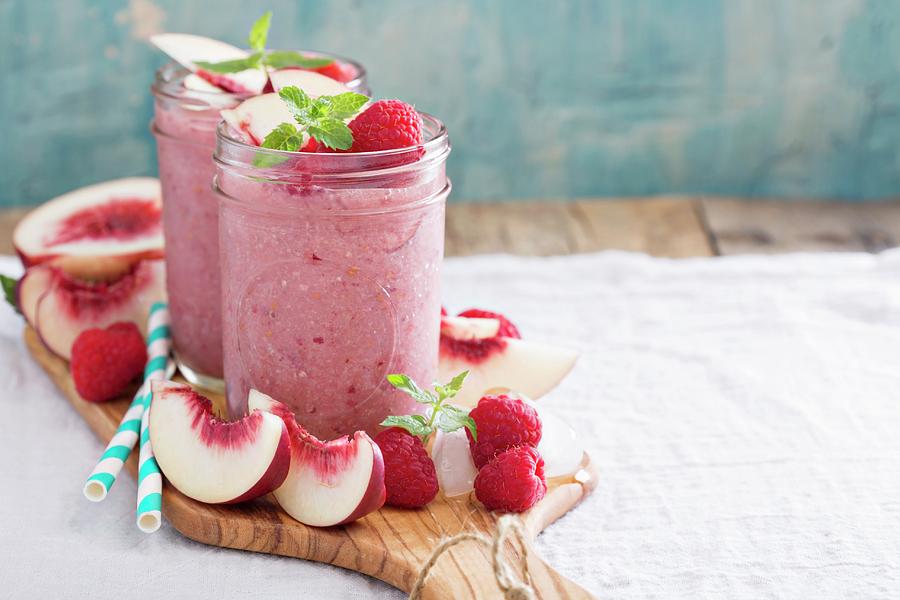 White Peach And Raspberry Smoothies In Jars Photograph by Elena Veselova