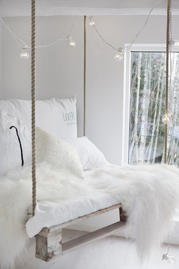 White Sheepskin, White Cushions And Fairy Lights On Diy Pallet Swing Photograph by Annette Nordstrom