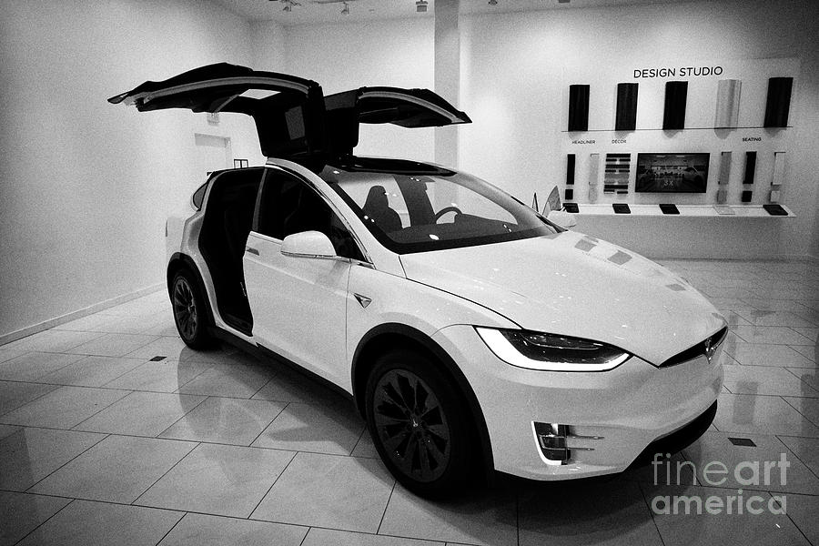 White Tesla Model X With Falcon Wing Doors Open During Celebration Display In A Tesla Gallery Showro