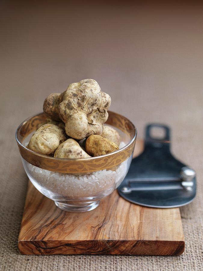 White Truffles In A Glass Bowl On A Wooden Board Photograph by Rob Whitrow