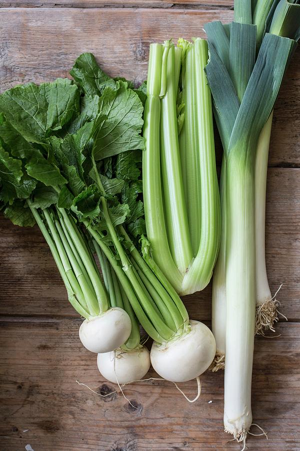 White Turnip, Celery And Leek On A Wooden Background Photograph by Sabine Steffens