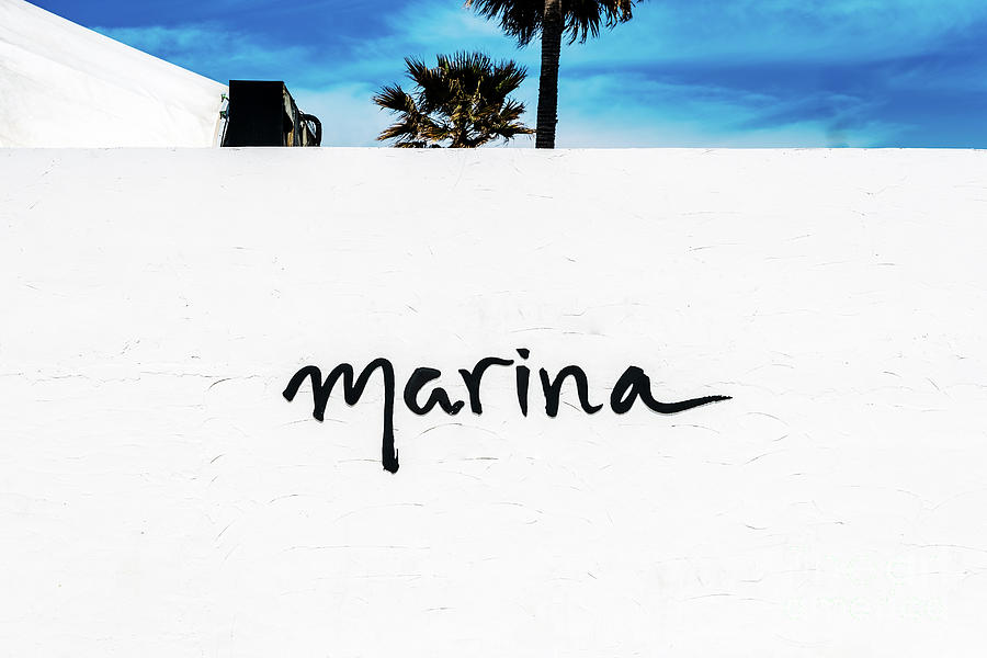 White wall with the word Marina, with palm trees in the backgrou Photograph by Joaquin Corbalan