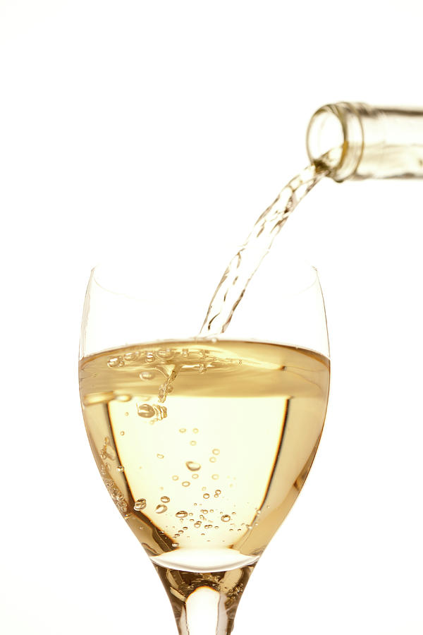 White Wine Pouring Into A Glass Photograph by Ross Durant Photography