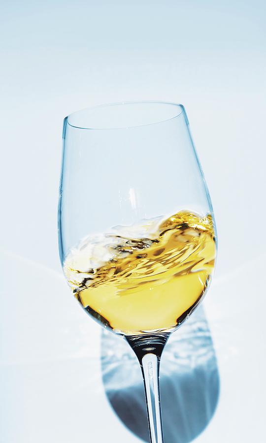 White Wine Swirling In A Glass Photograph by Jalag / Gtz Wrage