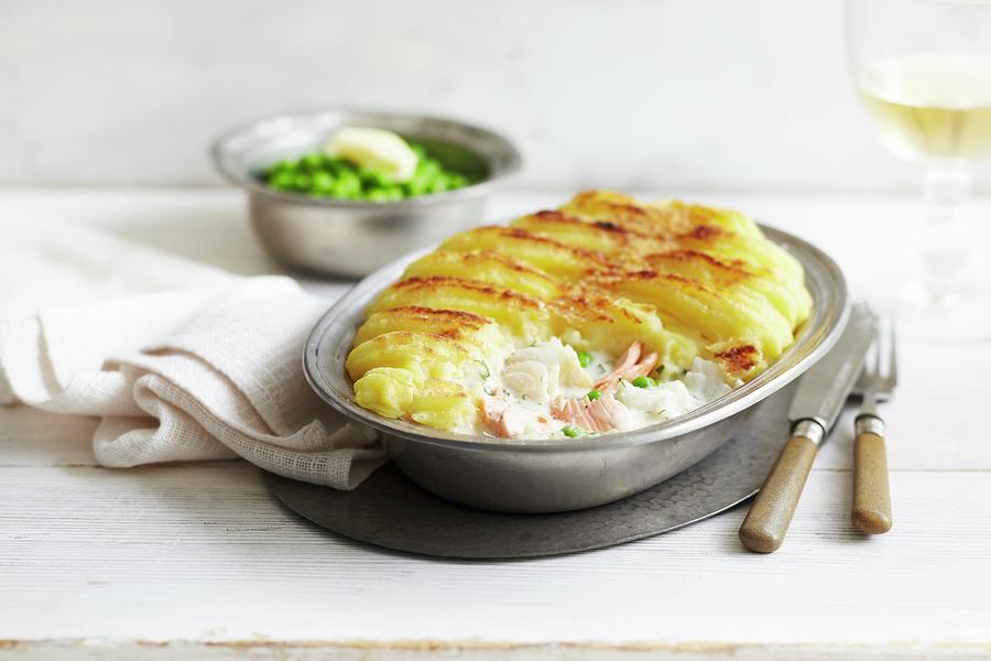 Whiting And Salmon Pie With A Mashed Potato Topping Served With Peas Photograph by Charlotte Tolhurst