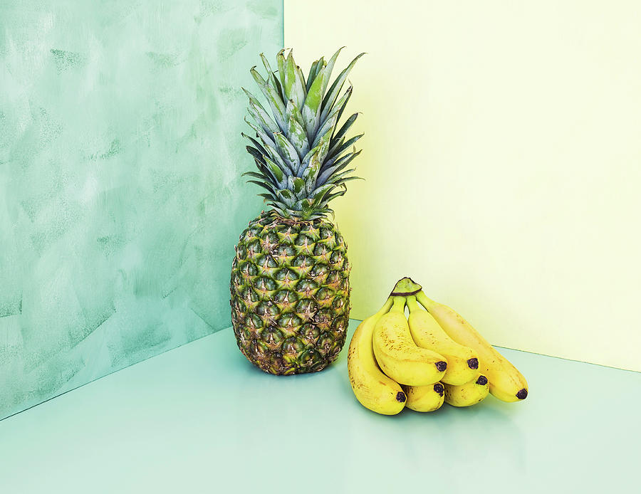 Whole Ananas And Bunch Of Bananas Over Yellow And Green Background Photograph by Sofya Bolotina