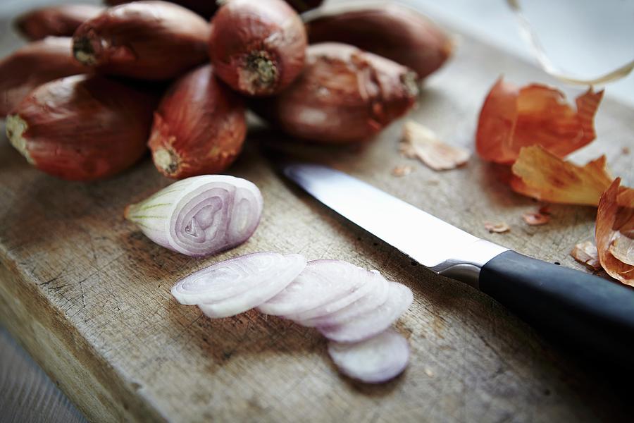 Whole And Sliced Shallots On A Wooden Board Photograph by Riess Studio ...