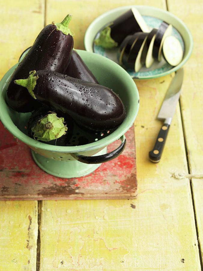 Whole Aubergines And Aubergine Slices Photograph by Jonathan Gregson