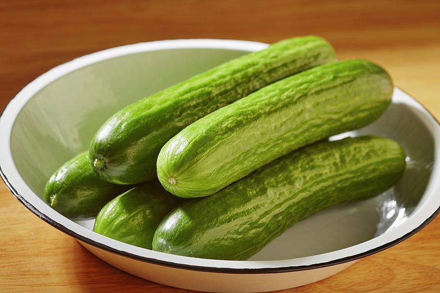 Whole Fresh Asian Cucumbers In An Enamel Bowl Photograph by Brian Yarvin