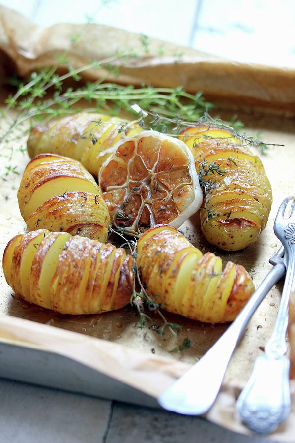 Whole Sliced Potatoes Roasted With Garlic And Thyme Photograph by Doutreligne