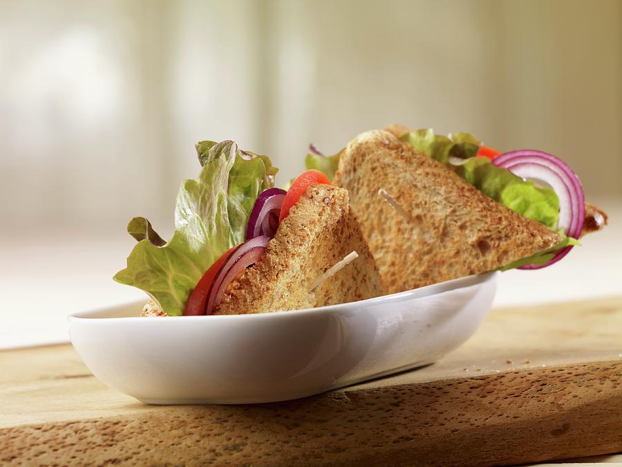 Wholegrain Bread Sandwich Filled With Batavia Lettuce, Onion Rings And Tomatoes Photograph by Studio R. Schmitz