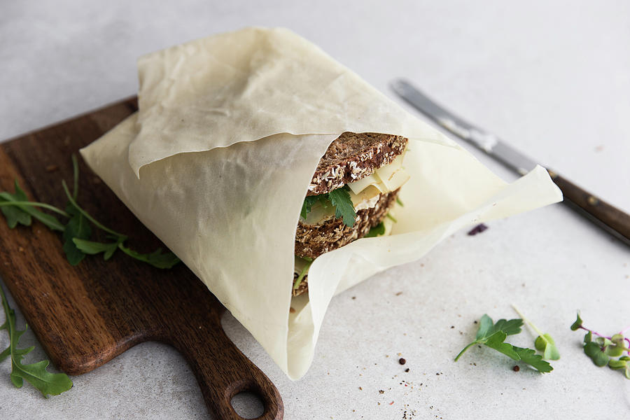 Wholegrain Sandwiches With Cheese Wrapped In Paper Photograph by Flora Emmer
