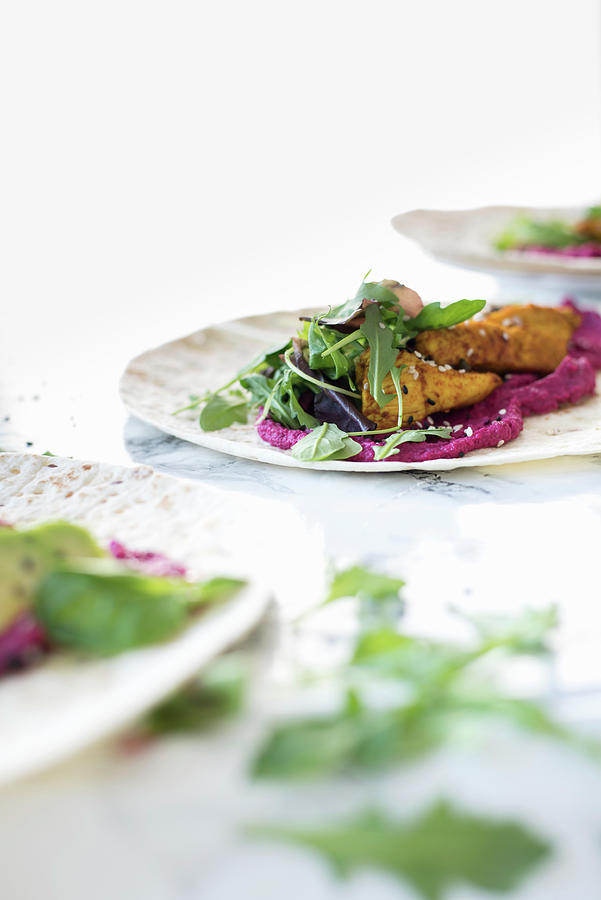 Wholegrain Wraps With Beetroot Hummus, Avocado, Turmeric Chicken, Sesame Seeds And Rocket Photograph by Healthylauracom