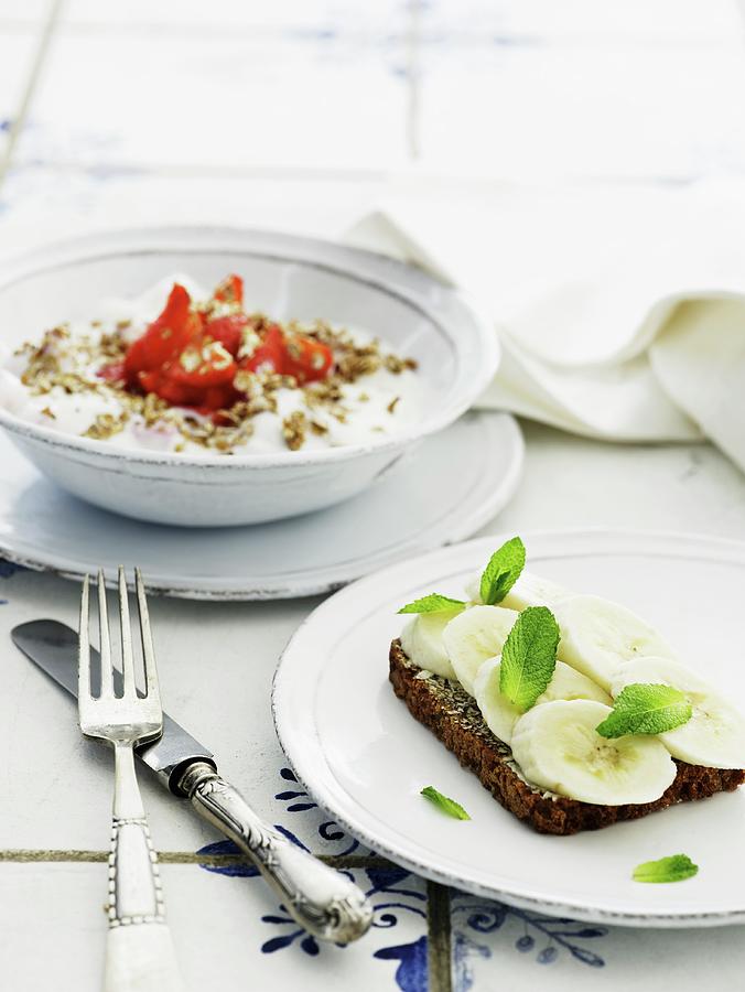 Wholemeal Bread With Banana, And Muesli With Strawberries Photograph by Mikkel Adsbl