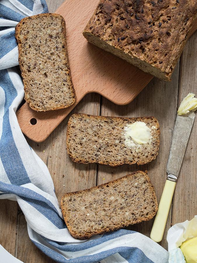 Wholemeal Bread With Flax Seeds And Sunflower Seeds, One Slice Spread With Butter Photograph by Magdalena Paluchowska