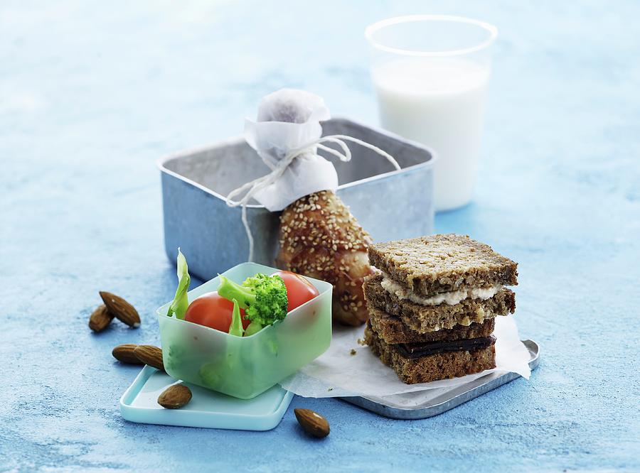 Wholemeal Sandwiches, Chicken Legs, Vegetables, Almonds And Milk For Lunch Photograph by Mikkel Adsbl