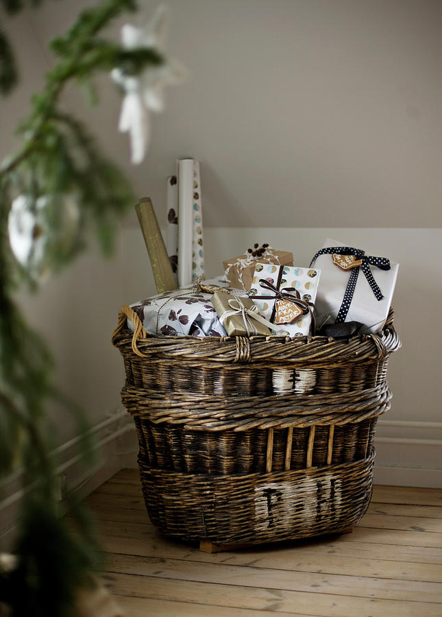 Wicker Basket Filled With Christmas Presents Photograph by Lykke Foged & Morten Holtum