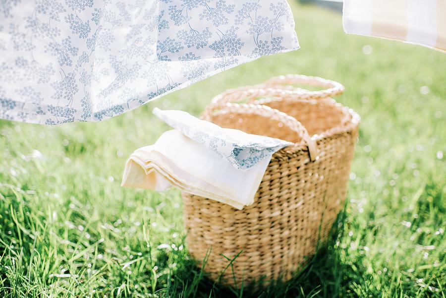Wicker Basket Filled With Linen On The Grass For Washing Photograph by Cavan Images
