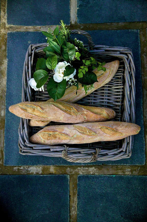 Wicker Tray Of Bread And Flowers Photograph by Karen Thomas