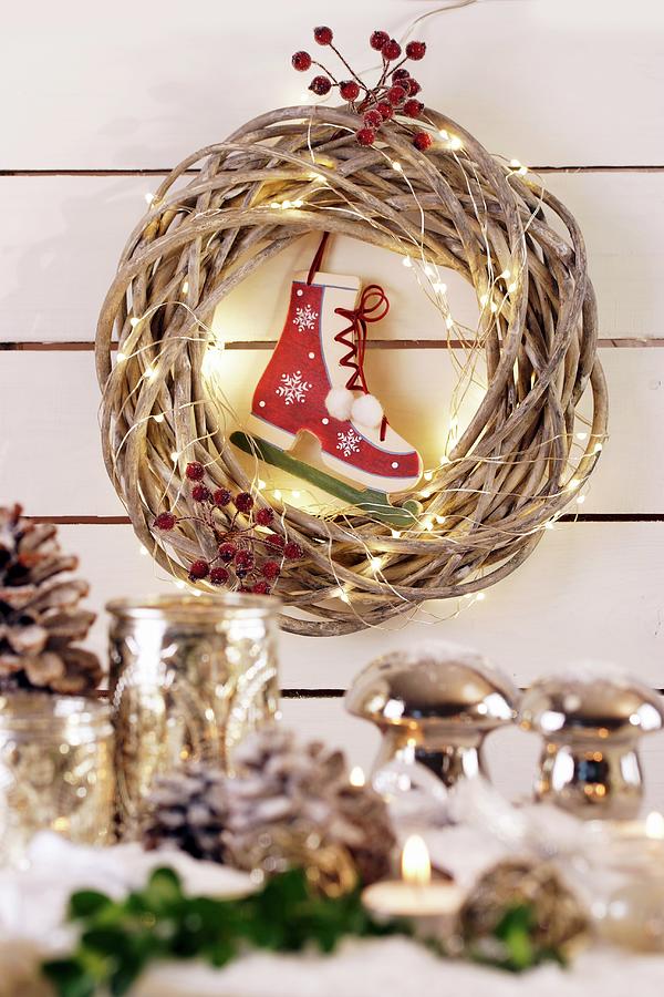 Wicker Wreath With Fairy Lights And Ice Skate Bauble Photograph by Angelica Linnhoff